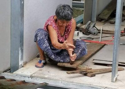 Tea's mom cleaning wood for the Local Divers shop