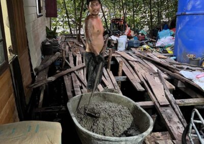 Tea working hard, mixing up a batch of concrete for the posts for the Local Divers shop.